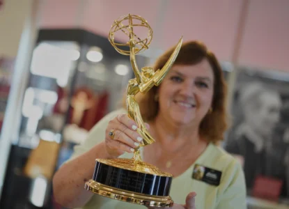 The Archbishop Fulton Sheen Museum tour coordinator, Rhonda Bachman, holds an Emmy award won by the late Archbishop Fulton Sheen, in Peoria, Ill., on July 15, 2026. (Credit: Jessie Wardarski/AP.)